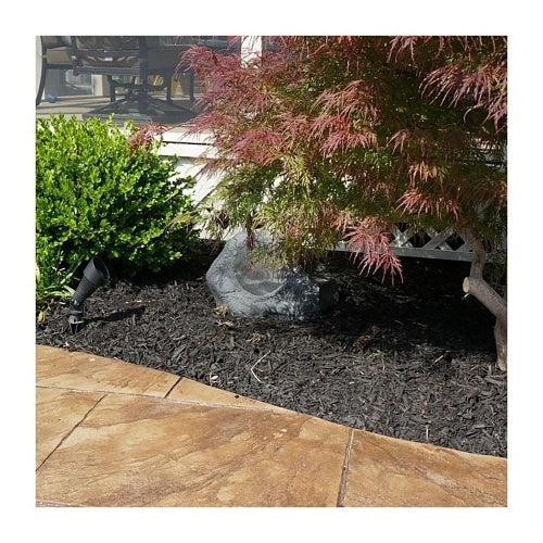 ES-ROCK-DVC-8-GRA installed in landscaping